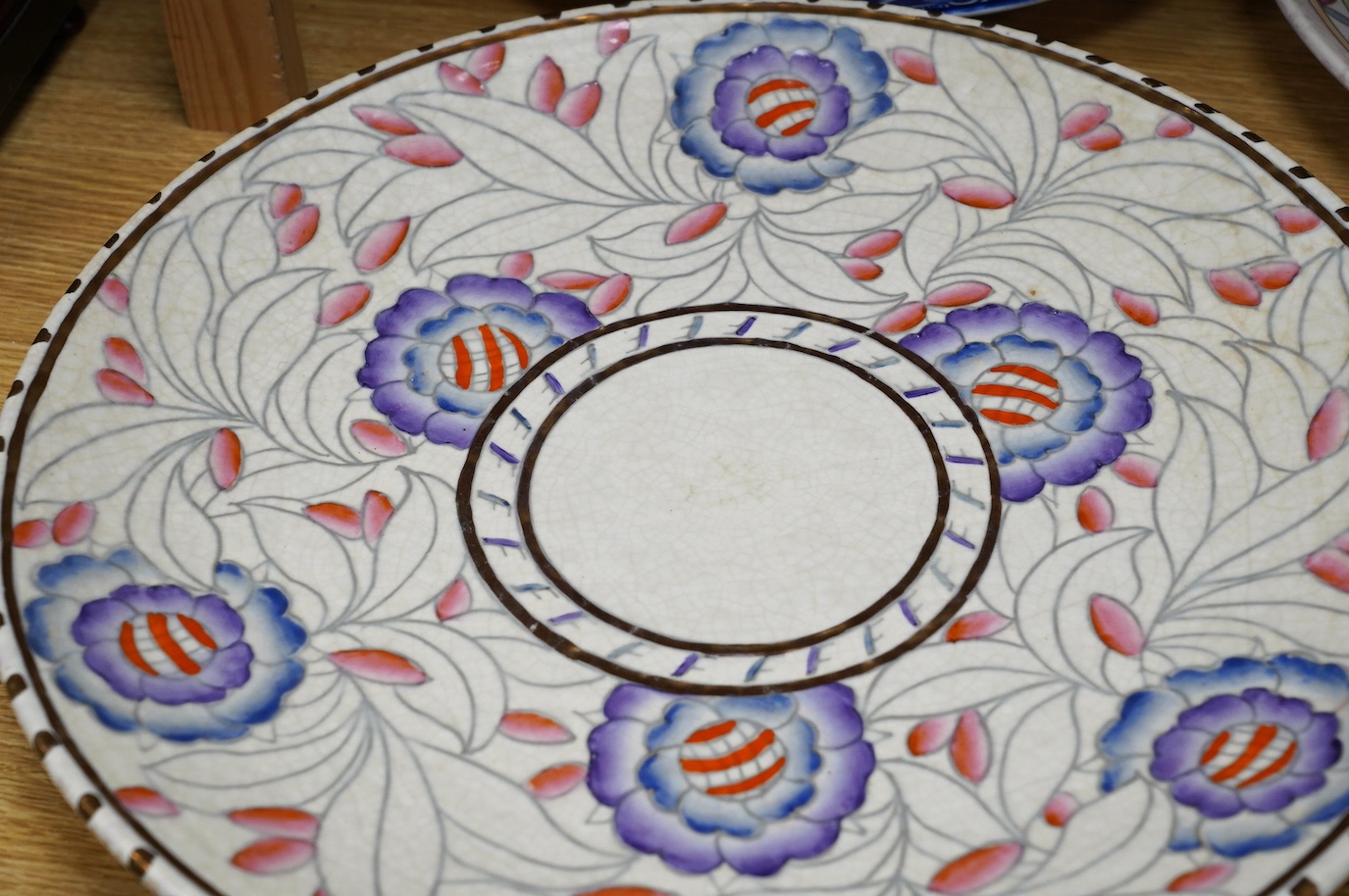 Two Charlotte Rhead signed chargers, a similar signed matching plate and vase and a ‘Mikado’ Burslem blue and white Oriental style charger designed by Frederick Rhead, largest 45cm diameter. Condition - good